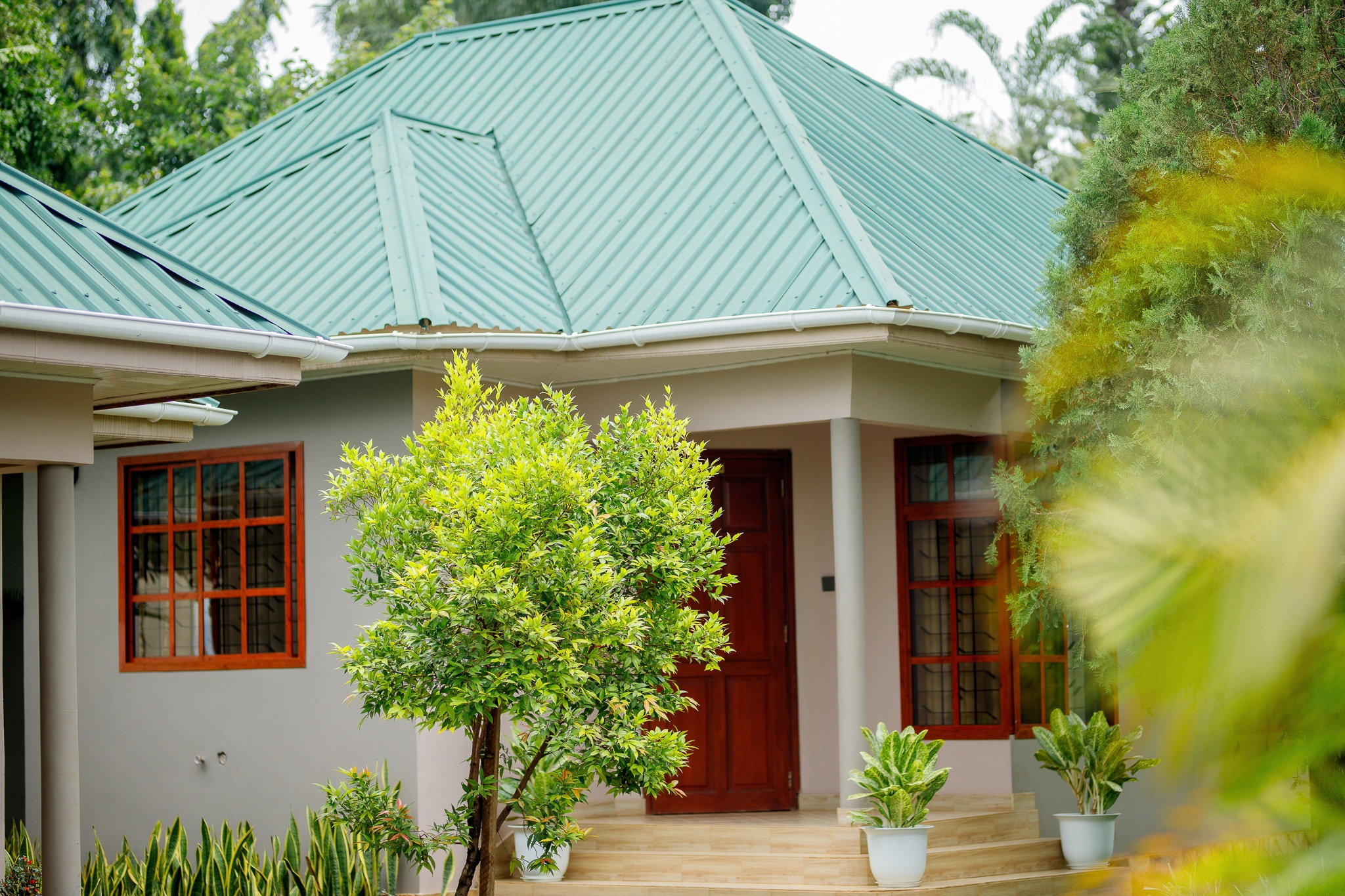 Charming house exterior with green roof and landscaping